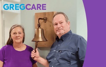 Greg Rodgers with his wife ringing the cancer bell