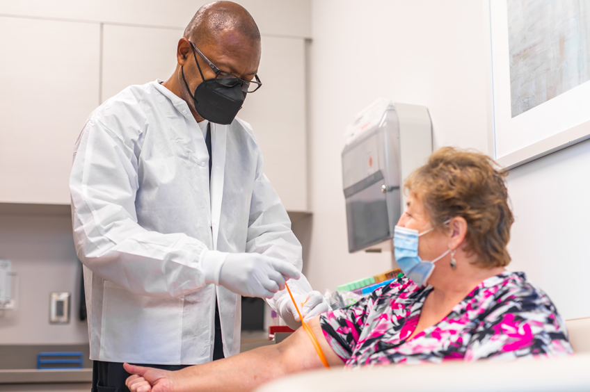 Wellstar lab technician drawing blood from a patient.