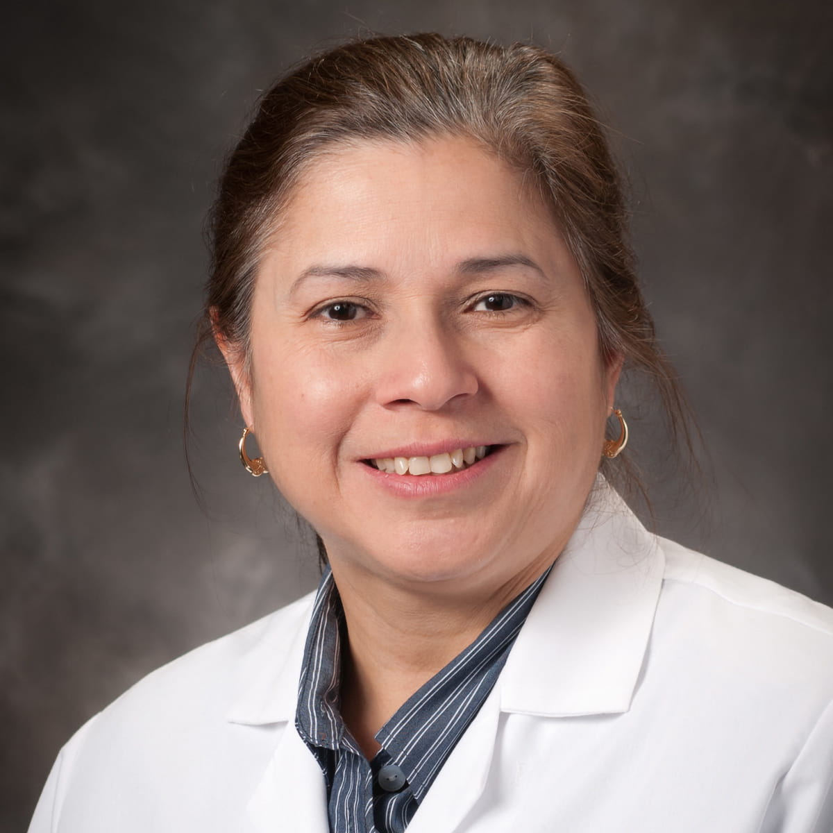 A friendly headshot of Ada Mercado, MD