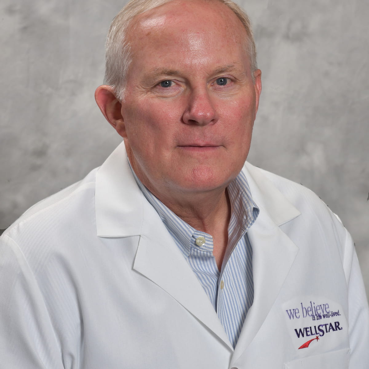 A friendly headshot of John Coggins, MD