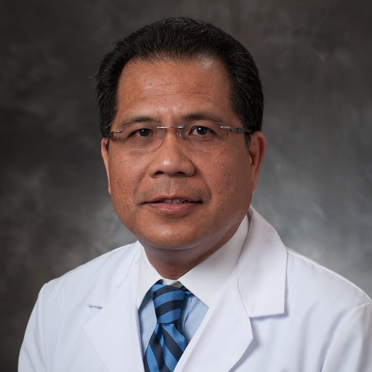 A friendly headshot of Medel Reyes, MD