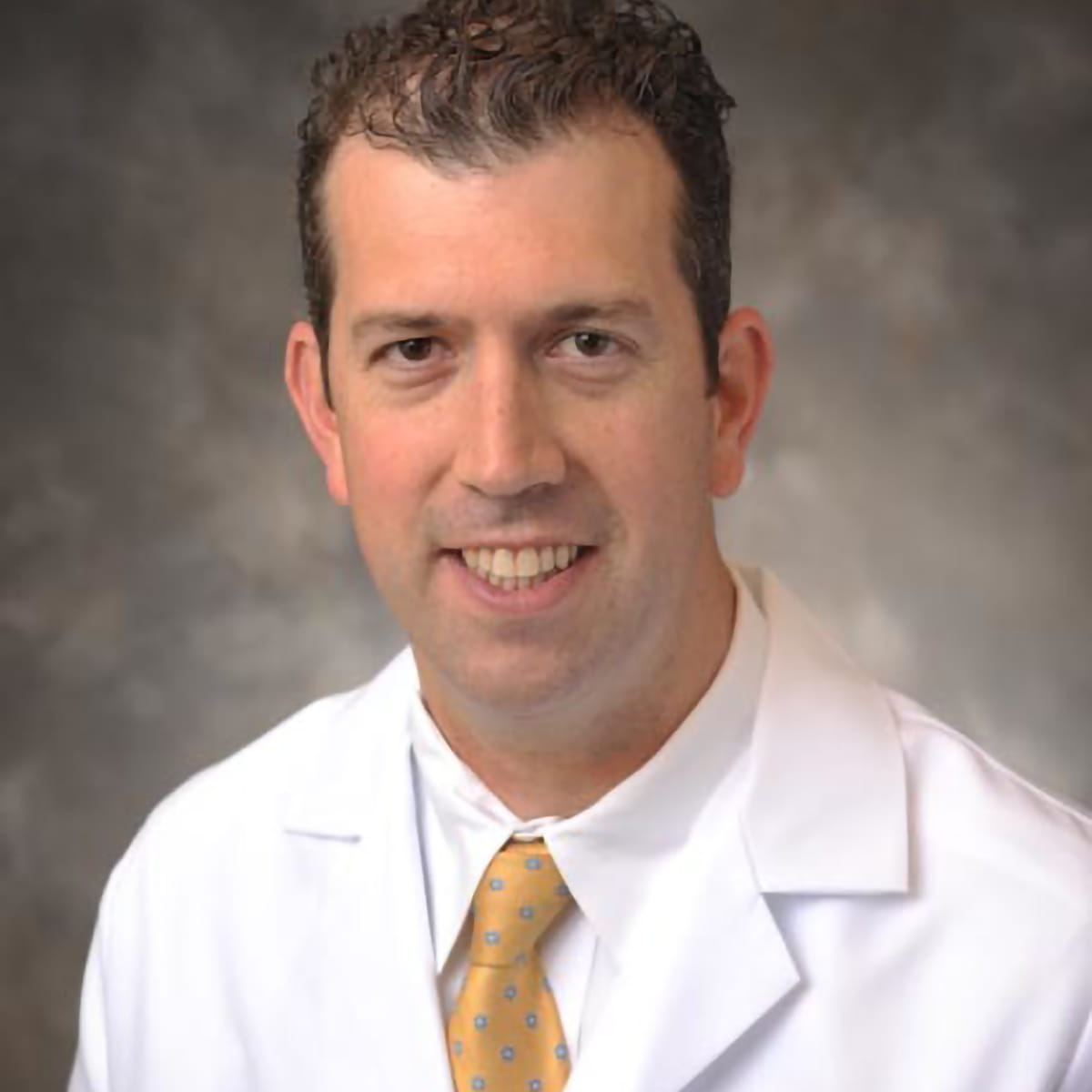 A friendly headshot of Travis Bowles, MD